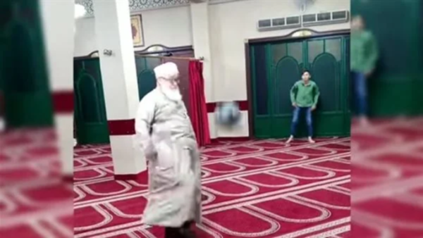 Imam playing football in a mosque 