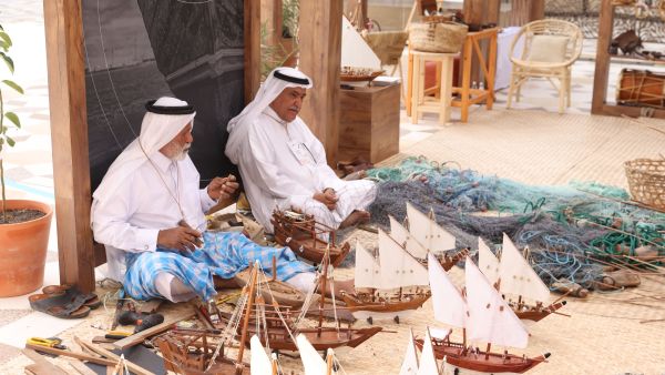 the public interacts with indigenous practices displayed at earthna village at barahat msheireb