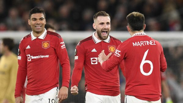 (From L) Manchester United's Brazilian midfielder Casemiro, Manchester United's English defender Luke Shaw and Manchester United's Argentinian defender Lisandro Martinez celebrate at the end of the UEFA Europa league knockout round play-off second leg football match between Manchester United and FC Barcelona at Old Trafford stadium in Manchester, north west England, on February 23, 2023. Manchester United won 2 - 1 against FC Barcelona. (Photo by Oli SCARFF / AFP)