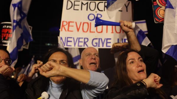 Israelis take to streets, despite judicial reforms freeze
