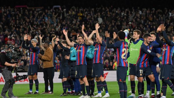Barcelona's players celebrate at the end of the Spanish league football match between FC Barcelona and Real Madrid CF at the Camp Nou stadium in Barcelona on March 19, 2023. (Photo by LLUIS GENE / AFP)