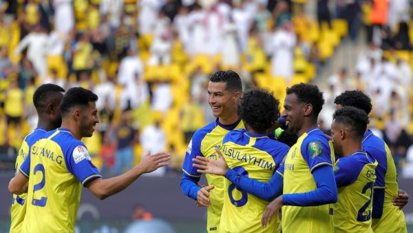 Nassr's Portuguese forward Cristiano Ronaldo (C) and other teammates celebrate after their team scored a goal during the King Cup quarter-final football match between al-Nassr and Abha at Mrsool Park Stadium in Riyadh on March 14, 2023. (Photo by Fayez NURELDINE / AFP)