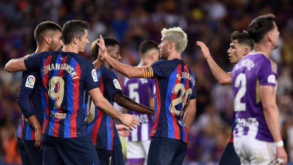 Barcelona's Spanish defender Sergi Roberto (C) celebrates with teammates after scoring his team's fourth goal during the Spanish League football match between FC Barcelona and Real Valladolid FC at the Camp Nou stadium in Barcelona on August 28, 2022. (Photo by Josep LAGO / AFP)