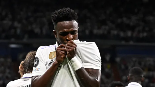 Real Madrid's Brazilian forward Vinicius Junior celebrates with teammates scoring his team's first goal during the UEFA Champions League semi-final first leg football match between Real Madrid CF and Manchester City at the Santiago Bernabeu stadium in Madrid on May 9, 2023. (Photo by JAVIER SORIANO / AFP)