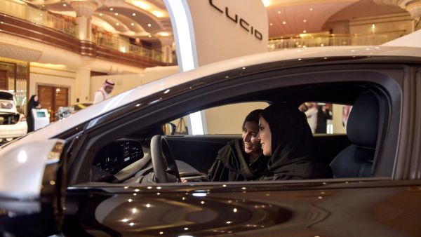 A Picture shows hostesses in a car manufactured by US electric vehicle maker Lucid Group at the KSA Green Transition Journey exhibition in the Red Sea port of Jeddah. AFP Lucid Cars