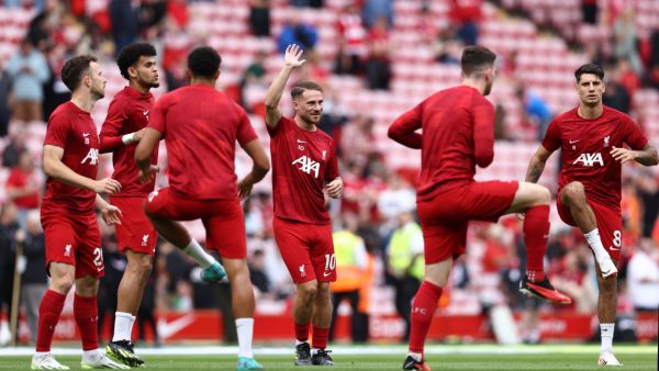 Liverpool's Argentinian midfielder #10 Alexis Mac Allister (C) warms up ahead of the English Premier League football match between Liverpool and Bournemouth at Anfield in Liverpool, north west England on August 19, 2023. (Photo by Darren Staples / AFP)