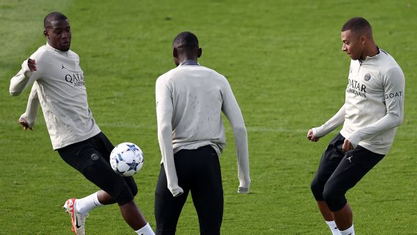 Paris Saint-Germain's French forward #07 Kylian Mbappe (R) fights for the ball with Paris Saint-Germain's French defender #26 Nordi Mukele during a training session at Poissy, west of Paris on September 18, 2023, on the eve of their UEFA Champions League Matchday 1 football match against Borussia Dortmund. (Photo by FRANCK FIFE / AFP)