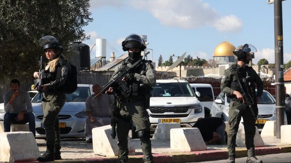 Israeli occupation forces stand guard as Palestinians take part in Friday