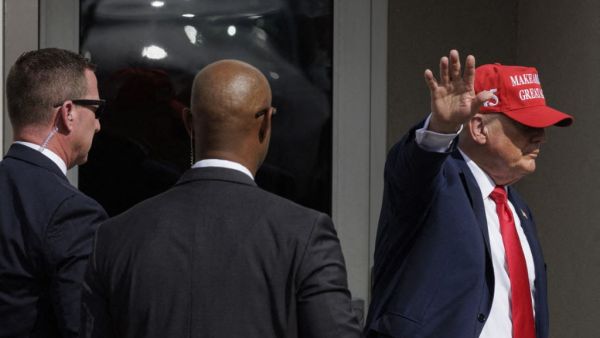 Former President Donald Trump waves to the crowd after giving remarks at the South Texas International airport on November 19, 2023 in Edinburg, Texas. (Michael Gonzalez/ AFP)