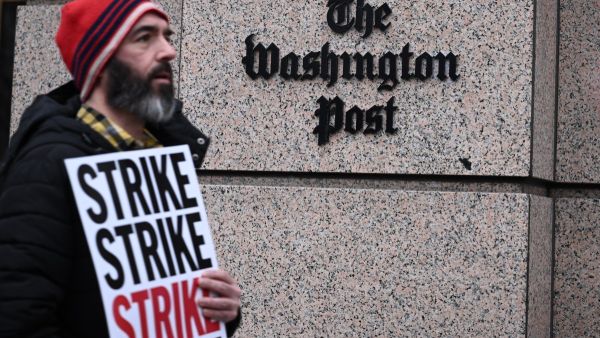 Employees of the Washington Post, joined by supporters, walk the picket line during a 24 hour strike, outside of Washington Post headquarters. (Brendan SMIALOWSKI/ AFP)