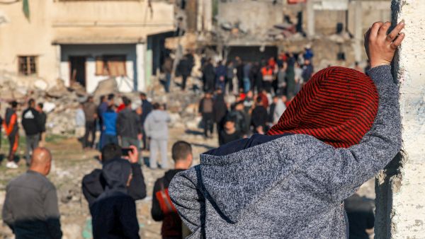 Israel bombs Gaza: People gather to inspect the rubble of a building destroyed by Israeli bombardment in southern Gaza on December 19, 2023. (Mohammed Abed/ AFP)