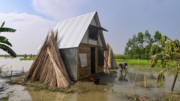 The "Khudi Bari" or "tiny house" -- resilient homes made on bamboo stilts rising out of the floodwaters that are also easy to move to safer locations when needed -- offer hope to millions. (Photo by Munir UZ ZAMAN / AFP) Bangladesh