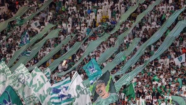 Ahli's supporters lift banners during the Saudi Pro League football match between Al-Nassr and Al-Ahli at the King Saud University Stadium in Riyadh, on September 22, 2023. (Photo by Fayez Nureldine / AFP)