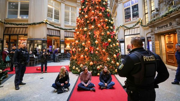 Climate activists spray Christmas trees with orange paint in Germany. (Jan Woitas/ X)