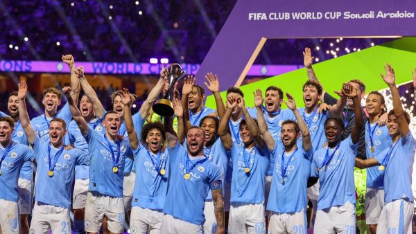 Manchester City players celebrate with their winning trophy at the end of the FIFA Club World Cup 2023 football final match against Brazil's Fluminense at King Abdullah Sports City Stadium in Jeddah on December 22, 2023. (Photo by Giuseppe CACACE / AFP)