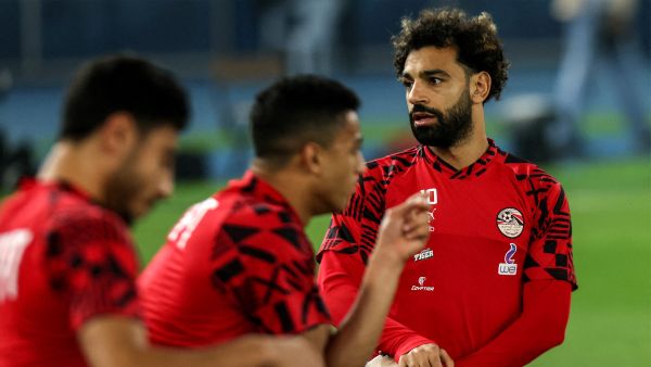 Egypt's forward Mohamed Salah (R) warms up before the start of the friendly football match between Belgium and Egypt at the Jaber Al-AhmadQ Stadium in Kuwait City on November 18, 2022. (Photo by YASSER AL-ZAYYAT / AFP)