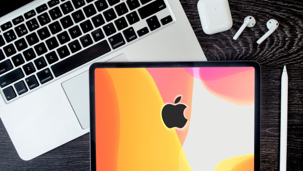 Apple Macbook Pro, second generation Airpods. IPad pro tablet with Pencil top view, flat lay (Shutterstock\ Edited by Albawaba) Apple patents new MacBook controversial feature