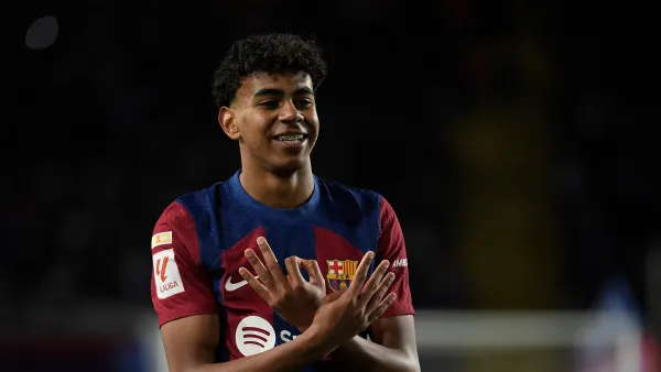 Barcelona's Spanish forward #27 Lamine Yamal celbrates scoring the opening goal during the Spanish league football match between FC Barcelona and Granada FC at the Estadi Olimpic Lluis Companys in Barcelona on February 11, 2024. (Photo by Josep LAGO / AFP)