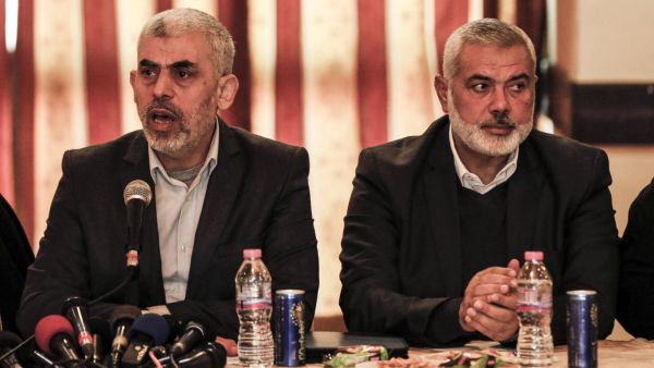 Yahya Sinwar (L), leader of the Islamist Hamas movement in the Gaza Strip, and the movement's political bureau head Ismail Haniyeh meet with the heads of families in Gaza City on December 26, 2017, to discuss recent developments on the reconciliation talks. (Photo by MAHMUD HAMS / AFP) Decision rests with Yahya Sinwar: Ceasefire talks officially begin in Qatar!