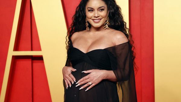 Vanessa Hudgens reveals on Oscars red carpet that she's pregnant with her first baby. (Photo by Michael TRAN / AFP)