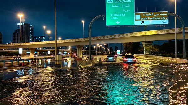 Motorisits drive along a flooded street following heavy rains in Dubai early on April 17, 2024. Dubai, the Middle East's financial centre, has been paralysed by the torrential rain that caused floods across the UAE and Bahrain and left 18 dead in Oman on April 14 and 15. (Photo by Giuseppe CACACE / AFP) Dubai
