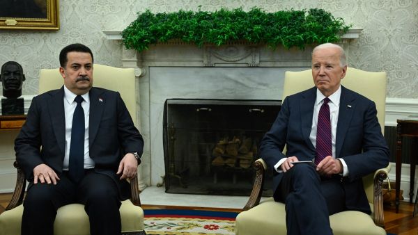 US President Joe Biden (R) meets with the Prime Minister of Iraq Mohammed Shia al-Sudani in the Oval Office of the White House in Washington, DC on April 15, 2024.