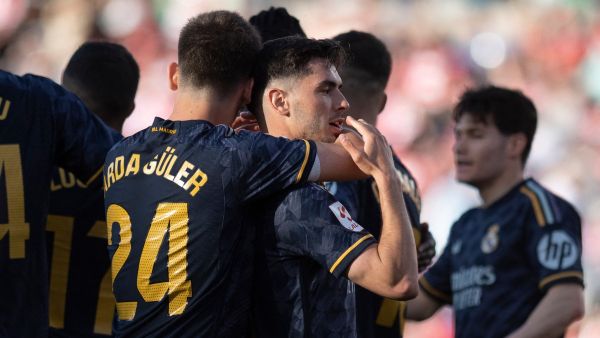 Real Madrid's Spanish forward #21 Brahim Diaz celebrates with teammates after scoring during the Spanish League football match between Granada FC and Real Madrid CF at Nuevo Los Carmenes stadium in Granada on May 11, 2024. (Photo by JORGE GUERRERO / AFP)