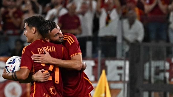 Roma's Italian midfielder #04 Bryan Cristante (R) celebrates with his teammate Roma's Argentine forward #21 Paulo Dybala after a goal during the Italian Serie A football match red between AS Roma and Empoli at the Olympic stadium in Rome on September 17, 2023. (Photo by Andreas SOLARO / AFP)
