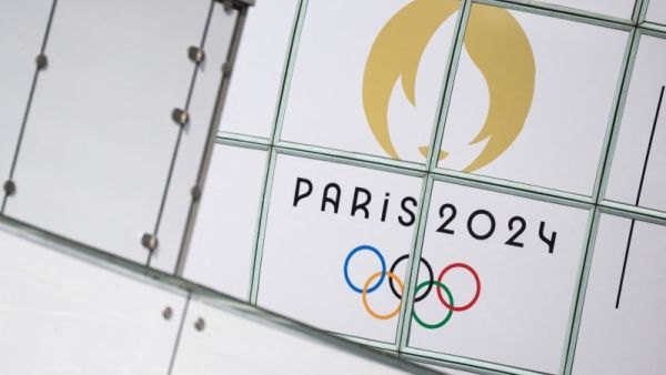 This photograph shows the logo of Paris 2024 Olympic games in front of skyscrapers at La Defense buisiness district on July 22, 2024, ahead of the Paris 2024 Olympic and Paralympic games. (Photo by Loic VENANCE / AFP)