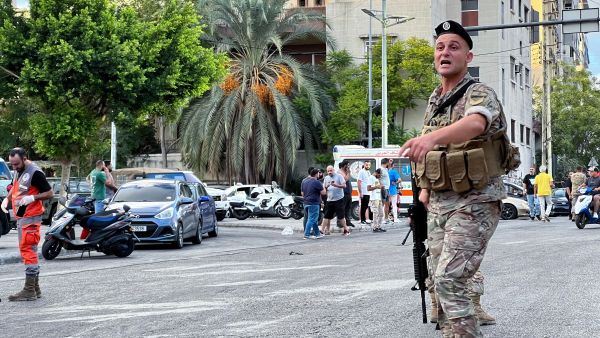 A Lebanese army soldier gestures at the scene of a reported pager device explosion in Saida in southern Lebanon on September 18, 2024. A second wave of device explosions killed three people in Hezbollah strongholds of Lebanon on September 18, raising fears of an all-out war between Israel and the Iran-backed militants. (Photo by Mahmoud ZAYYAT / AFP) pager explosions