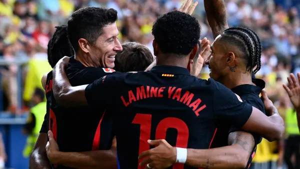 Barcelona's Polish forward #09 Robert Lewandowski celebrates with teammates after scoring his team's first goal during the Spanish league football match between Villarreal CF and FC Barcelona at La Ceramica stadium in Vila-real, on September 22, 2024. (Photo by JOSE JORDAN / AFP)