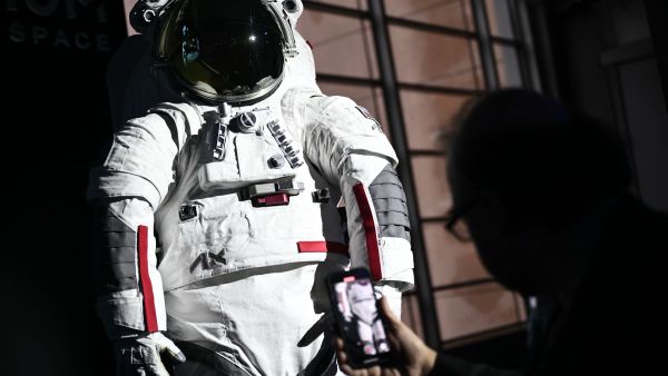 The AxEMU suit is pictured during a press conference of Prada and Axiom Space, as part of the presentation of the Axiom Extravehicular Mobility Unit designed and developed for the Artemis 3 lunar mission in collaboration with Prada, at the MiCo Convention Centre in Milan, northern Italy, on October 16, 2024.  (Photo by MARCO BERTORELLO / AFP) AxEMU suit