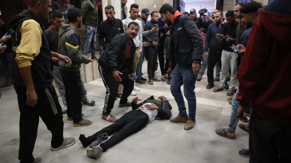 EDITORS NOTE: Graphic content / People gather around a wounded Palestinian lying on the ground at the Nasser hospital in Khan Yunis following Israeli strikes on the Mawassi Cafeteria in the southern Gaza Strip on November 11, 2024, amid the ongoing war between Israel and the Palestinian Hamas militant group. (Photo by BASHAR TALEB / AFP) Gaza hospitals