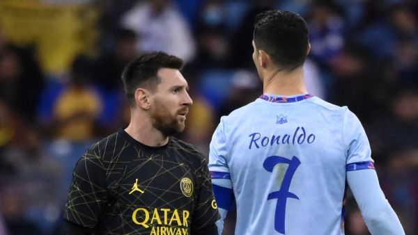Paris Saint-Germain's Argentine forward Lionel Messi (L) walks past Riyadh All-Star's Portuguese forward Cristiano Ronaldo (R) during the Riyadh Season Cup football match between the Riyadh All-Stars and Paris Saint-Germain at the King Fahd Stadium in Riyadh on January 19, 2023. (Photo by FRANCK FIFE / AFP)