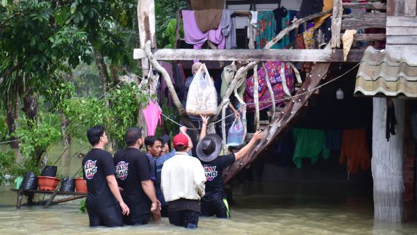 Volunteers distribute food supplies to flood-affected residents at Mueang district in Thailand's southern province of Narathiwat on November 30, 2024. (Photo by Madaree TOHLALA / AFP) Thailand