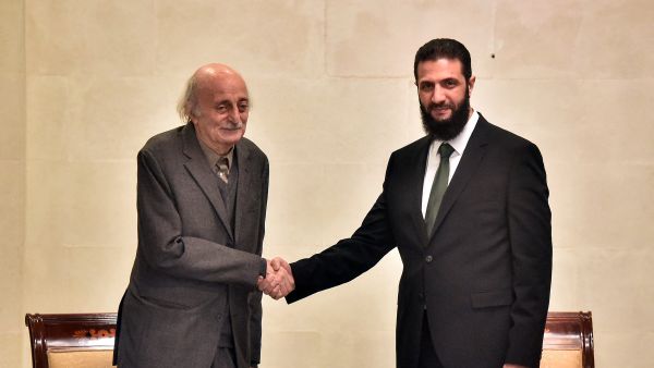 Walid Jumblatt (L), the Druze former leader of Lebanon's Progressive Socialist Party (PSP), shakes hands with Hayat Tahrir al-Sham (HTS) leader Ahmed al-Sharaa (also known as Abu Mohammad al-Jolani) during a visit to Damascus on December 22, 2024. 