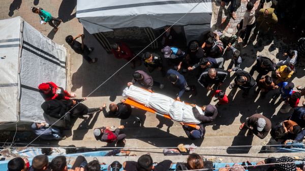 Mourners carry one of the bodies of victims who were killed in overnight Israeli bombardment in the north of the Bureij camp for Palestinian refugees, during the funeral in the camp in the central Gaza Strip on March 11, 2025. (Photo by Eyad BABA / AFP) Gaza ceasefire