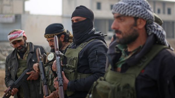 Fighters affiliated with the Turkish-backed Syrian National Army faction, stand guard along a road in the northeastern Manbij region, in Aleppo province on January 4, 2025, amid ongoing battles between Turkey-backed groups and Kurdish-led forces near the Tishreen Dam. In the latest clashes around the battleground northern town of Manbij, at least 24 fighters were killed, the Syrian Observatory for Human Rights war monitor said on January 2, despite US-led efforts to establish a truce in the area. (Photo by Aaref WATAD / AFP) Disputes stall prisoner swap between Syrian government and Kurdish forces