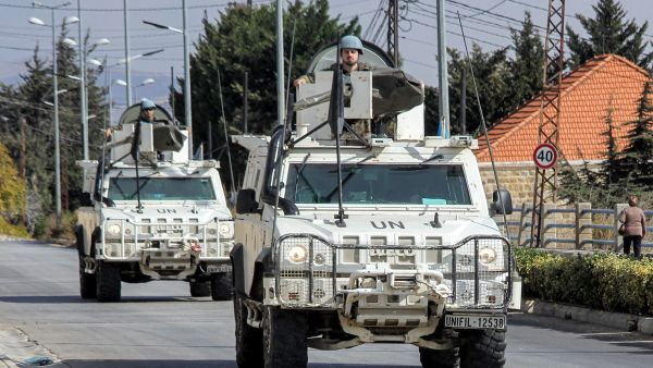 United Nations peacekeepers ride in vehicles