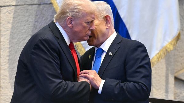 Israeli Prime Minister Benjamin Netanyahu whispers to US President Donald Trump (L) at the Israeli parliament, the Knesset, in Jerusalem on October 13, 2025. Hamas handed over the 20 surviving Israeli hostages on October 13 under a ceasefire agreement, as the US President and other world leaders geared up for a summit on Gaza. The releases are part of a ceasefire agreement brokered by the US President, with Israel due in return to free nearly 2,000 detainees held in its jails in exchange. (Photo by SAUL LOEB / POOL / AFP) Trump Reportedly ready to "Punish Netanyahu severely" if Gaza agreement collapses