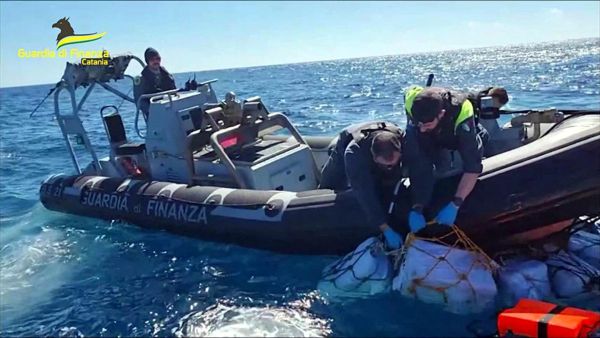 Italian narcotics police seizing drugs