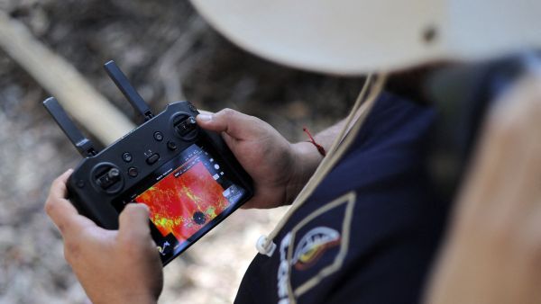 Firefighter using multispectral drones to check for wildfires