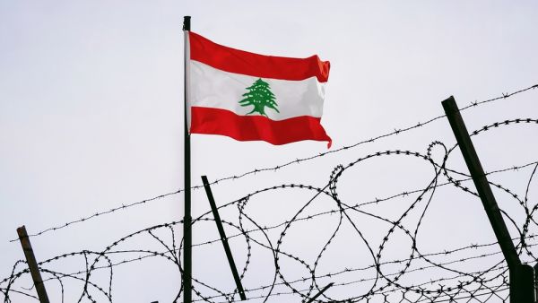 Lebanese flag behind barbed wire