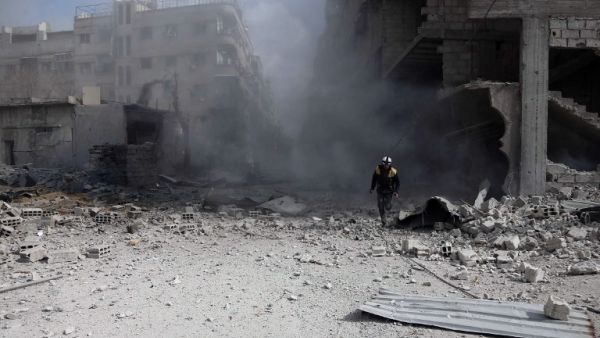 A civil Defense volunteer, known as the White Helmets, checks the site of a regime air strike in the rebel-held town of Saqba, in the besieged Eastern Ghouta region on the outskirts of the capital Damascus, on Feb. 23, 2018. Syrian regime air strikes and artillery fire hit the rebel-held enclave of Eastern Ghouta for a sixth straight day killing at least 32 civilians, as the world struggled to reach a deal to stop the carnage.
(ABDULMONAM EASSA / AFP)