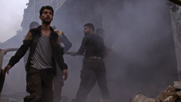 Members of the Syrian civil defense search for survivors in the aftermath of an air strike in the rebel-held town of Harem in the northwestern Idlib province on Mar. 22, 2018. 
(Aaref WATAD / AFP)