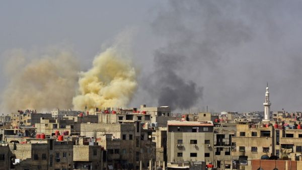 A picture taken in the Yarmuk Palestinian refugee camp in southern Damascus on Apr. 27, 2018 shows smoke billowing in the area during Syrian army shelling and airstrikes. (Rami al SAYED / AFP)