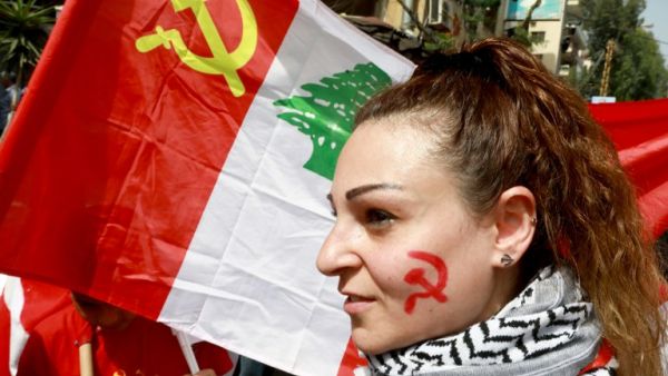 A supporter of the Lebanese Communist Party takes part in a march celebrating the International Labour Day in the Lebanese capital Beirut on May 1, 2018 / AFP