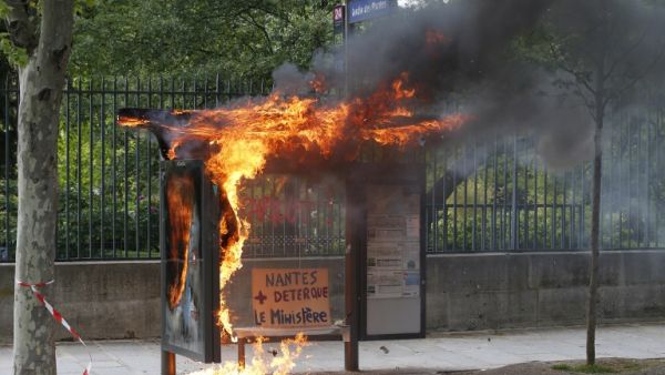 A bus stop was burned during a demonstration on the sidelines of the march for the annual May Day workers' rally, in Paris / AFP