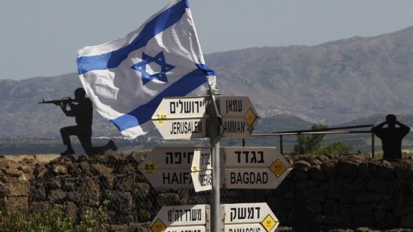 An Israeli flag is seen placed on Mount Bental in the Israeli-annexed Golan Heights on May 10, 2018. Israel's army said today it had carried out widespread raids against Iranian targets in Syria overnight after rocket fire towards its forces it blamed on Iran, marking a sharp escalation between the two enemies. Israel carried out the raids after it said around 20 rockets, either Fajr or Grad type, were fired from Syria at its forces in the occupied Golan Heights at around midnight.
(JALAA MAREY / AFP)