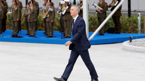 NATO Secretary General Jens Stoltenberg walks during the opening ceremony of the NATO (North Atlantic Treaty Organization) summit, at the NATO headquarters in Brussels, on July 11, 2018. 
GEOFFROY VAN DER HASSELT / AFP